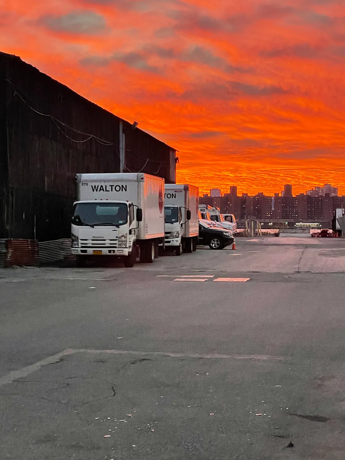 Line of parked trucks against a fiery sunset